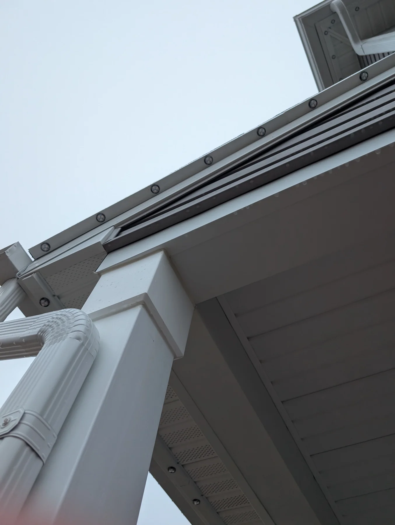 Closeup of permanent Christmas lights aluminum channel showing roofline measurement