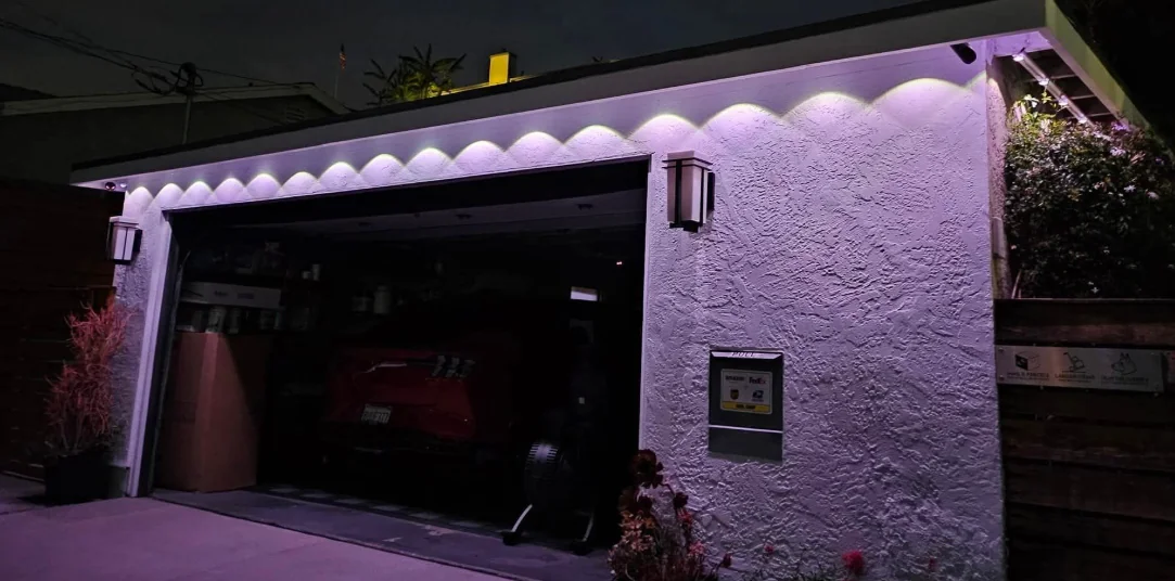 Nighttime photo of a garage with purple lights showing patchy uneven coverage and visible hot spots