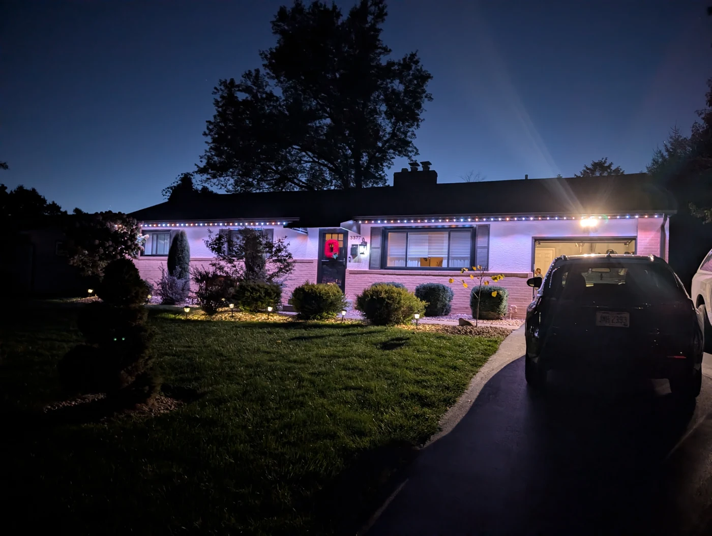 Colorful permanent lights on ranch home at night