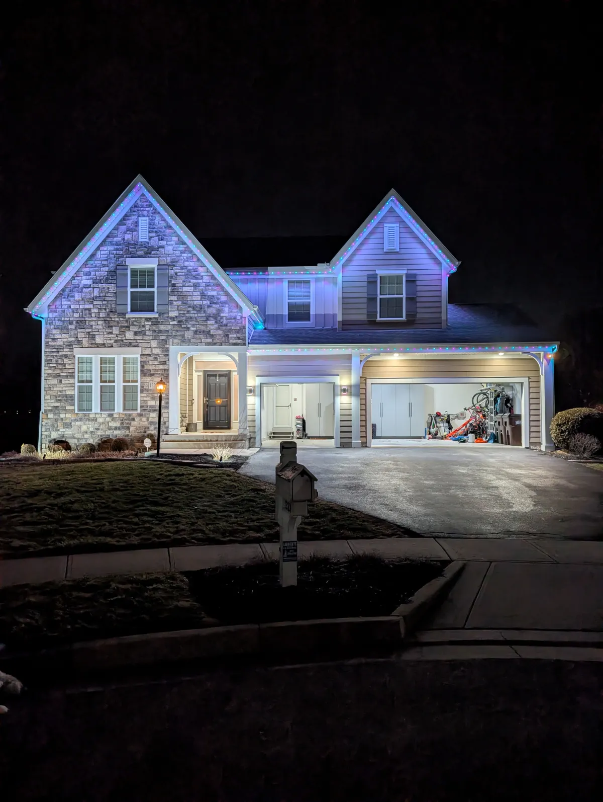 Multicolor permanent lights on stone two-story home at night