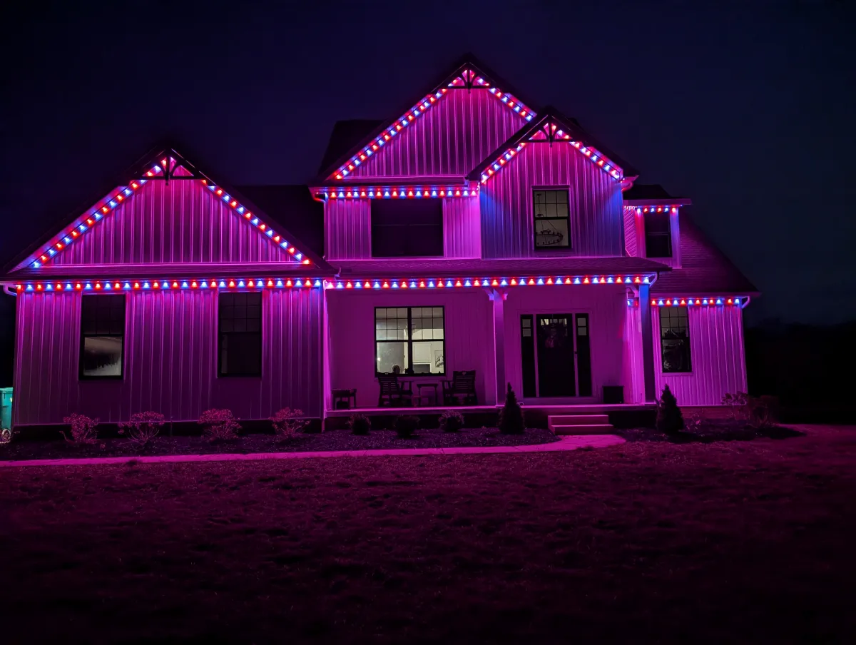 Permanent Christmas lights on modern farmhouse at night