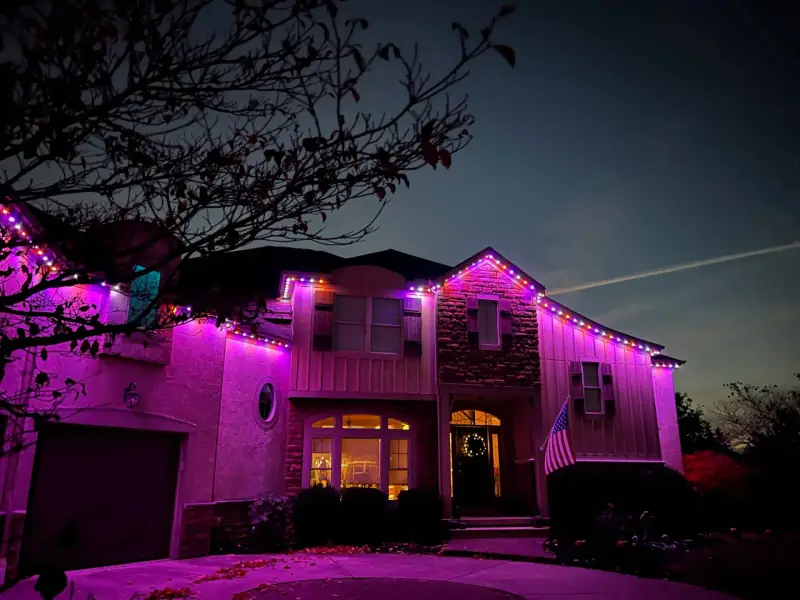 Purple permanent lights on large mansion at sunset in Columbus Ohio